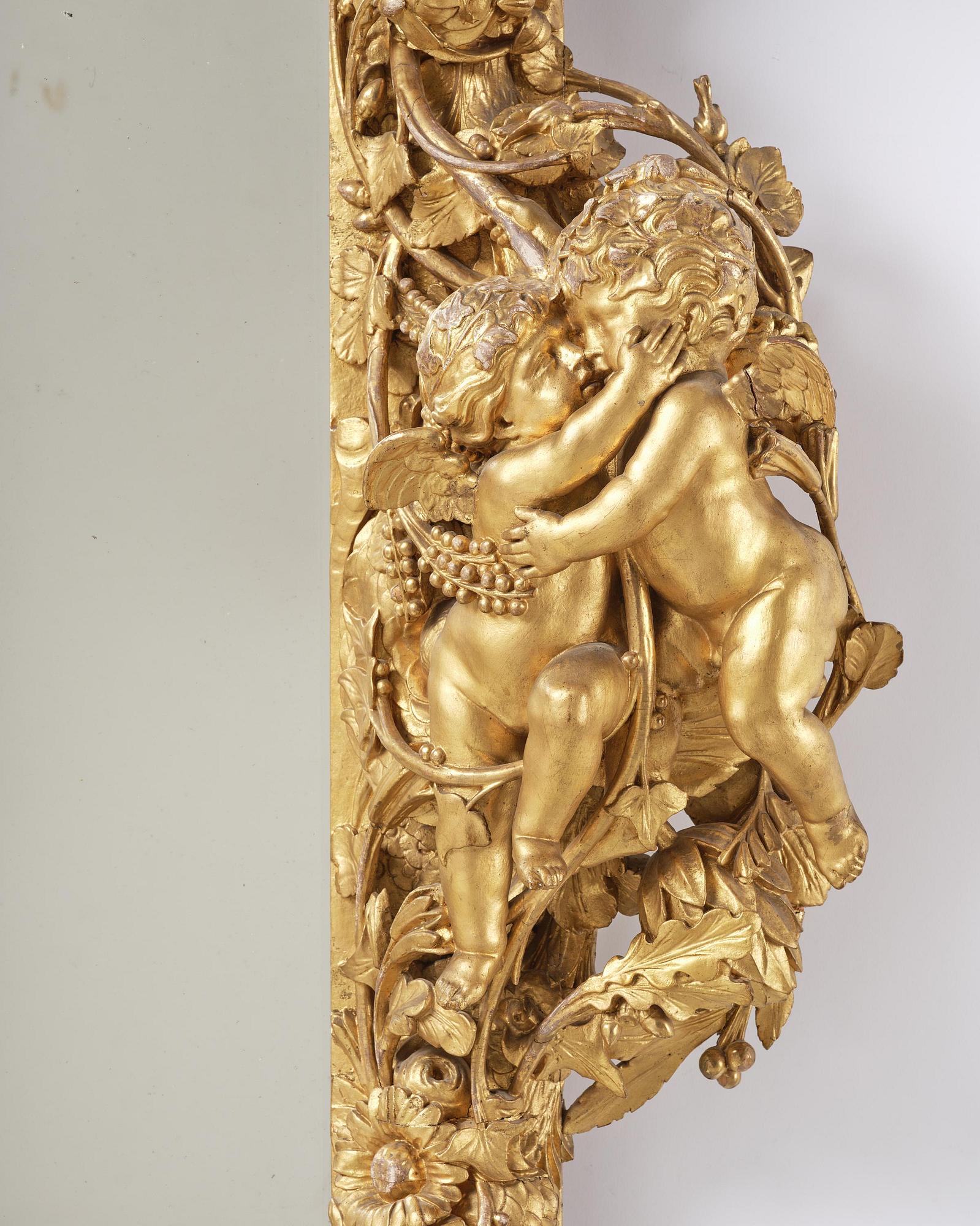 A presumably Dutch Louis XIV carved giltwood frame with mirror glass, in the style of Jean Le Pautre, late 17th century.