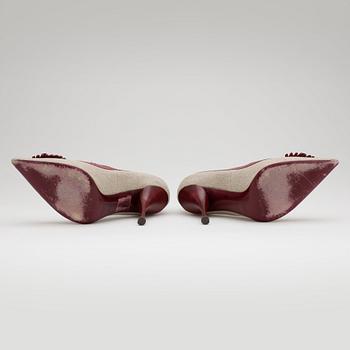 YVES SAINT LAURENT, a pair of red leather and canvas pumps.