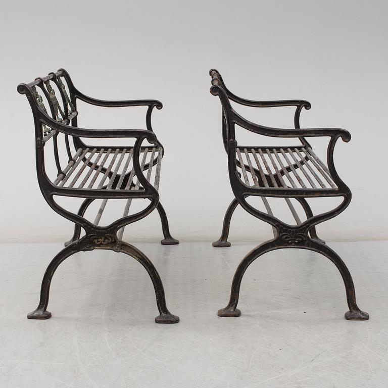 GARDEN SOFAS, a pair, cast iron, empire style, late 19th century.