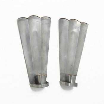 Nils Fougstedt, a matched pair of pewter and brass wall sconces, model A 60, Svenskt Tenn, Stockholm 1929 and 1932.