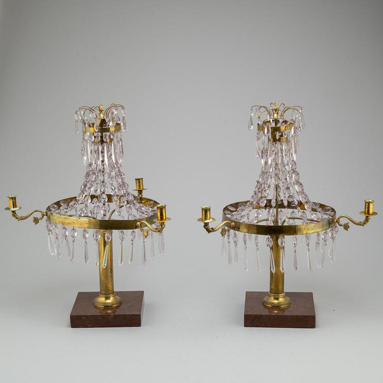 A pair of late Gustavian style three-light candelabra.