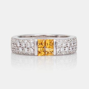 1084. A princess-cut yellow sapphire and circa 0.69 ct brilliant-cut diamond ring.