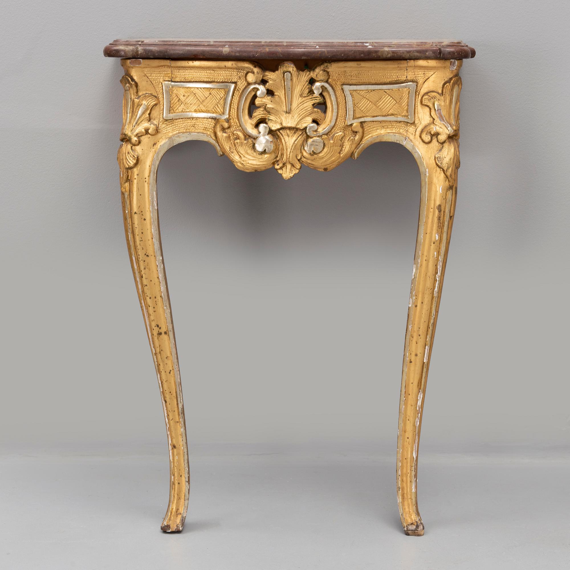 A rococo console table with a stone top, second half of the 18th century.