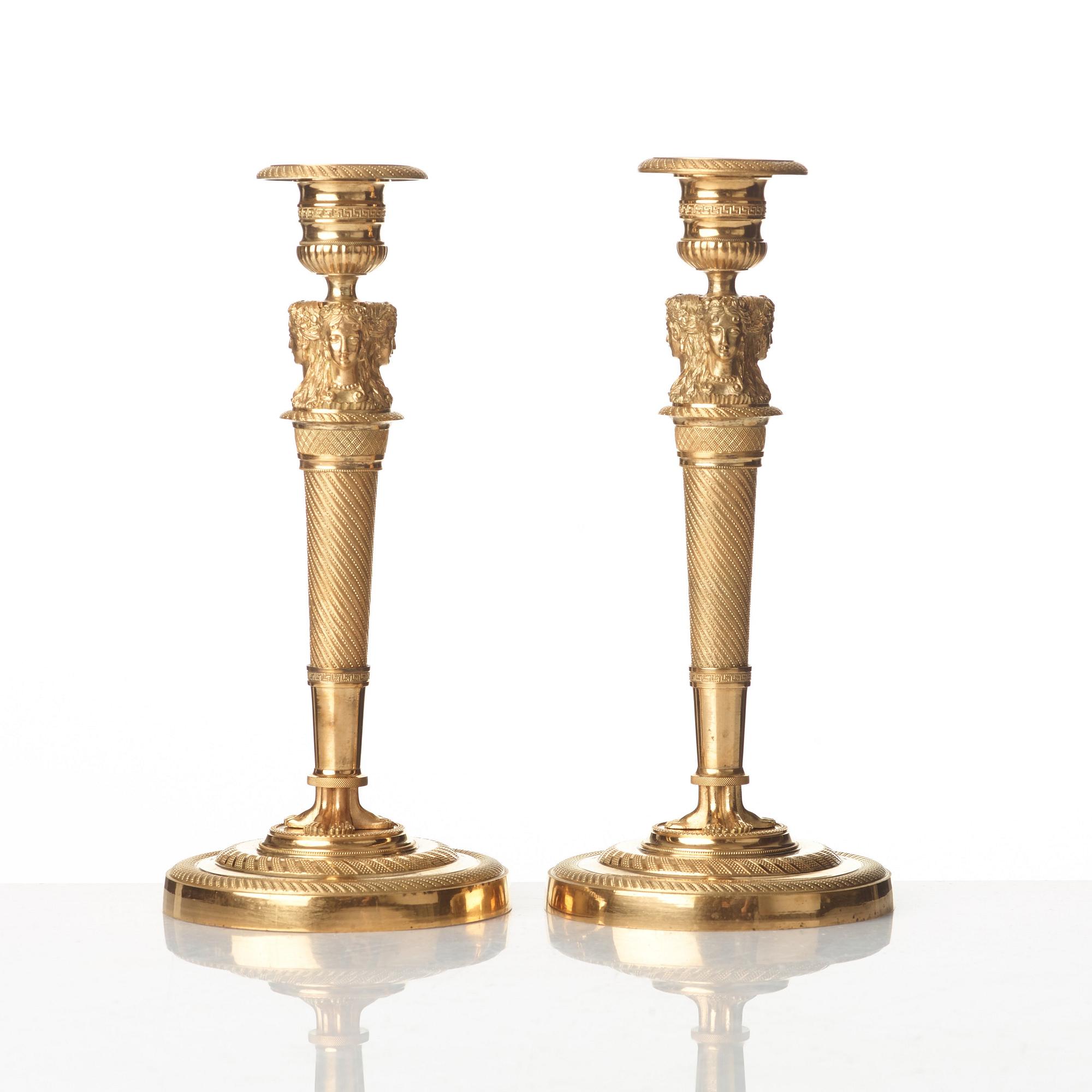 A pair of French Empire early 19th century gilt bronze candlesticks.