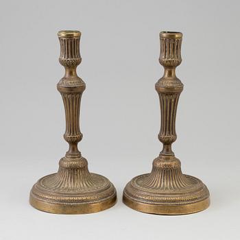 A pair of late 18th century bronze candlesticks.