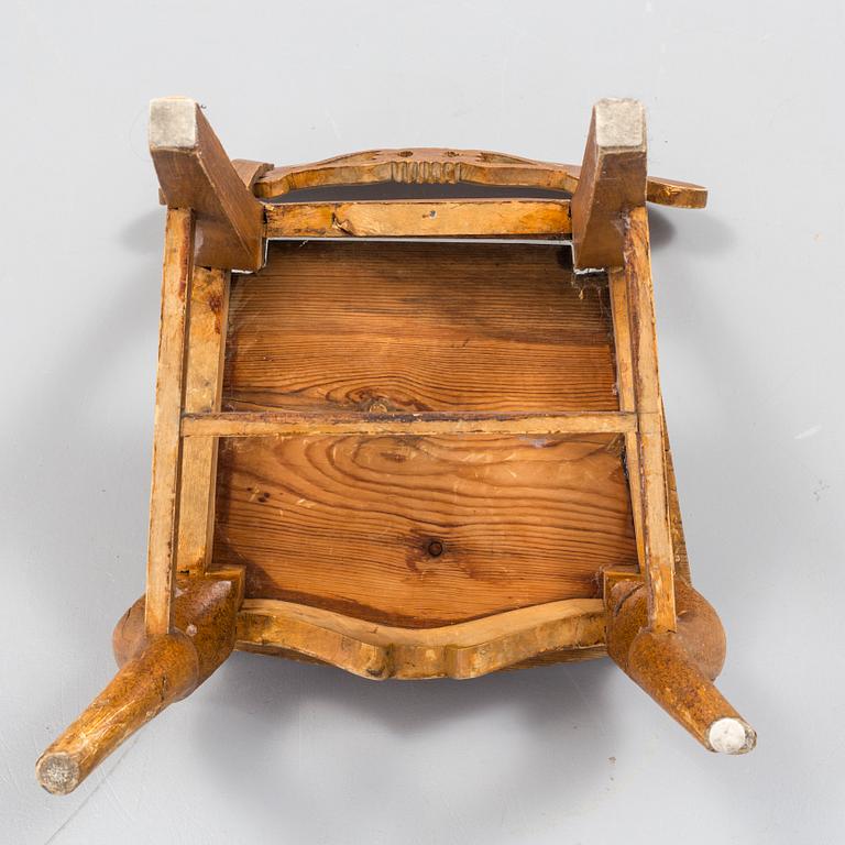 a wooden childrens chair from the 19th century.