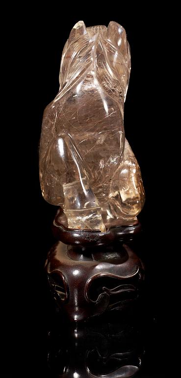 A smoky quartz figure of a reclining horse, China early 20th Century.
