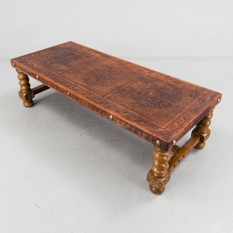 A Peruvian leather covered coffee table and pair of stools, second half of the 20th Century.