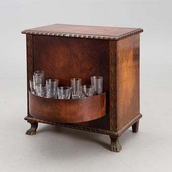 A WOODEN BAR CABINET.