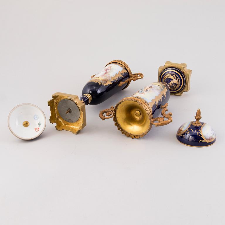 Pair of Sevres Chateau des Tuileries porcelain lidded urns, mid-19th century.