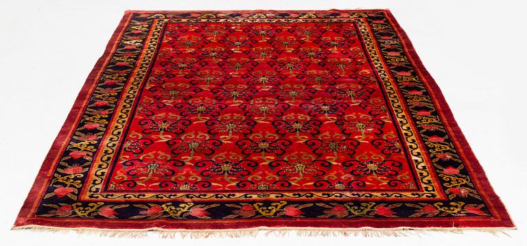 An East Turkestan silk carpet, c. 308 x 182 cm.