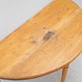 A round pine dining table/a pair of crescent shaped tables, Sweden, 19th century.