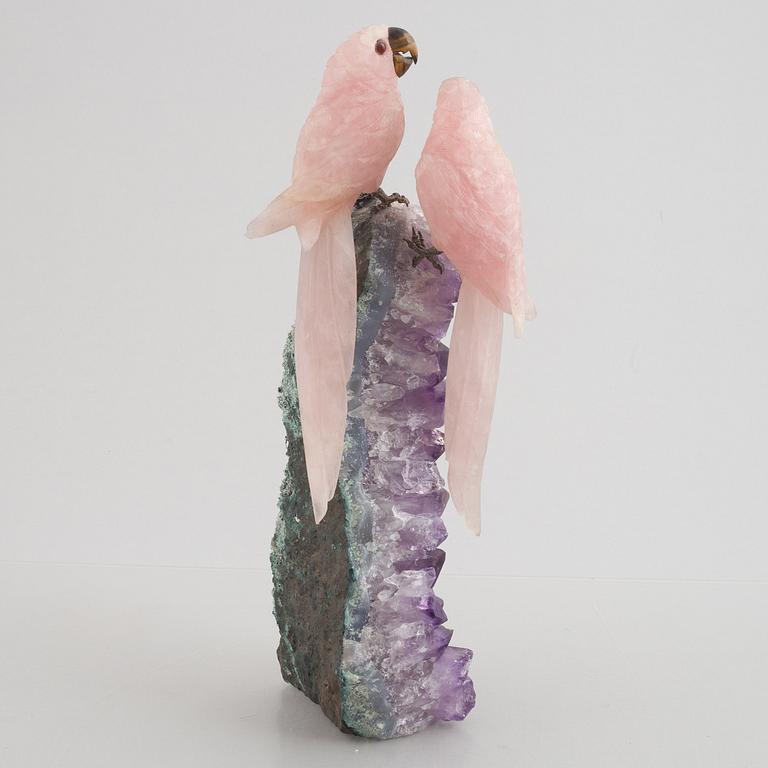 Sculpture, carved stone, birds on a quartz cliff.