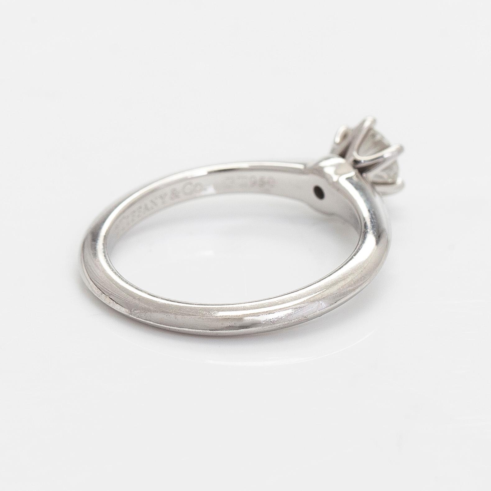 Tiffany & Co, a platinum solitaire ring with a brilliant-cut diamond.