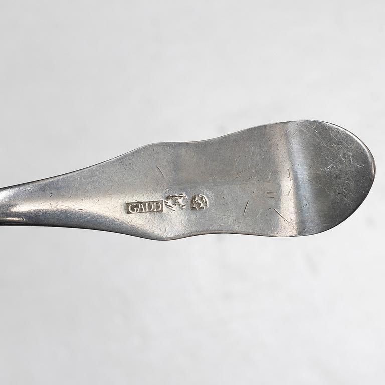 Seven silver spoons, including English and Swedish hallmarks.