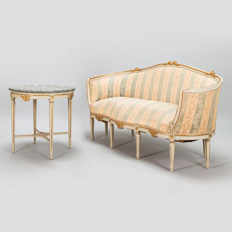 A Gustavian style sofa and table from early 20th century.