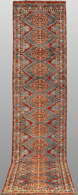 An oriental runner, c. 386 x 78 cm.