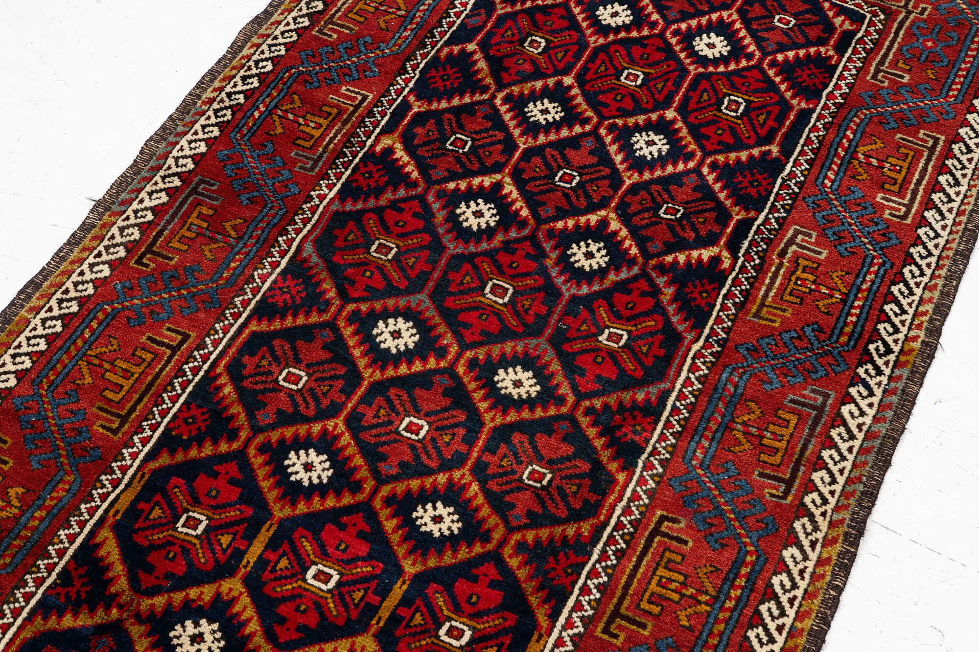 An antique Baluch rug, east Persian, ca 203 x 101 cm.