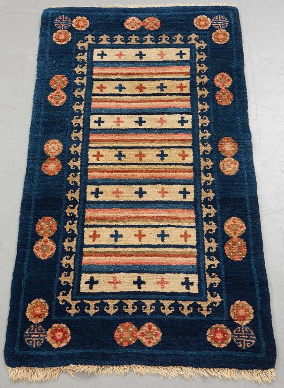 A rug, semi-antique Baotou, ca 108,5 x 56,5 cm.