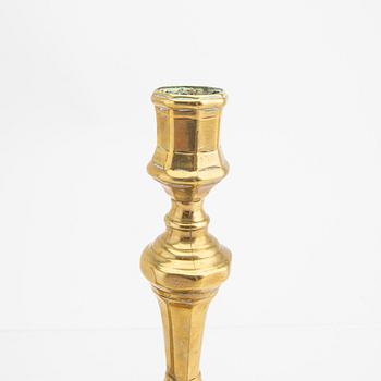 A pair of 18th century brass candle sticks.