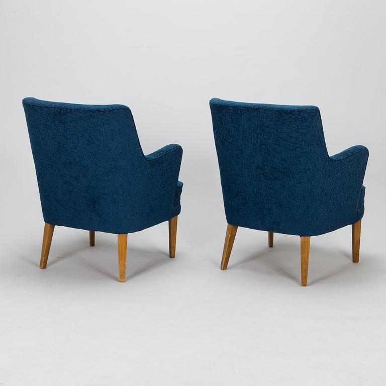 A pair of mid-20th-century armchairs.