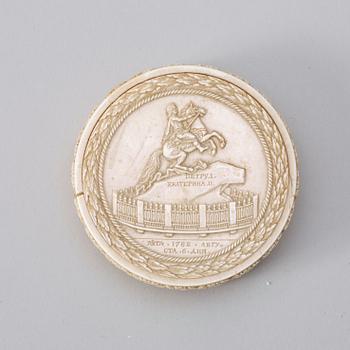 An ivory box with cover, dated 1782.