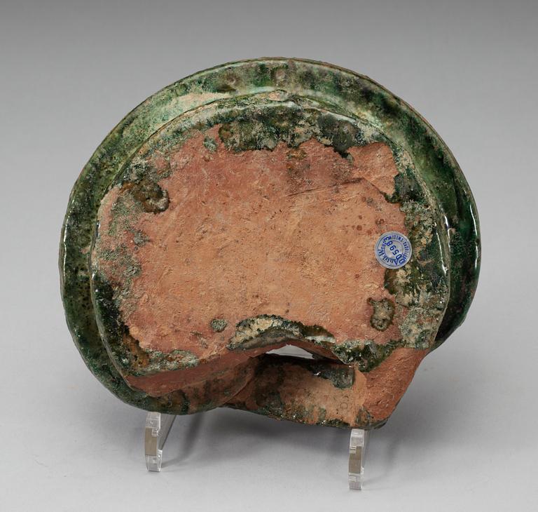 A green glazed heart shaped pigsty with pig, Han dynasty (206 BC- 220 AD).