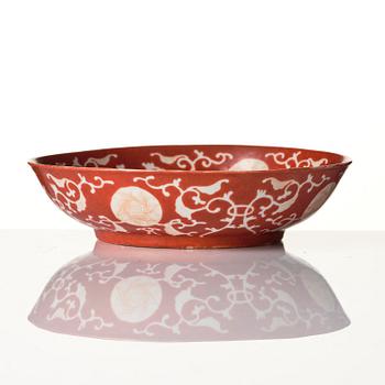 A coral-red reverse decorated dish, Qing dynasty with Guangxu mark and of the period (1875-1908).