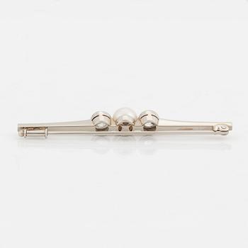 A 14K white gold brooch set with old-cut diamonds and a cultured pearl.