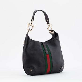 GUCCI, a black leather shoulder bag, "Jackie".