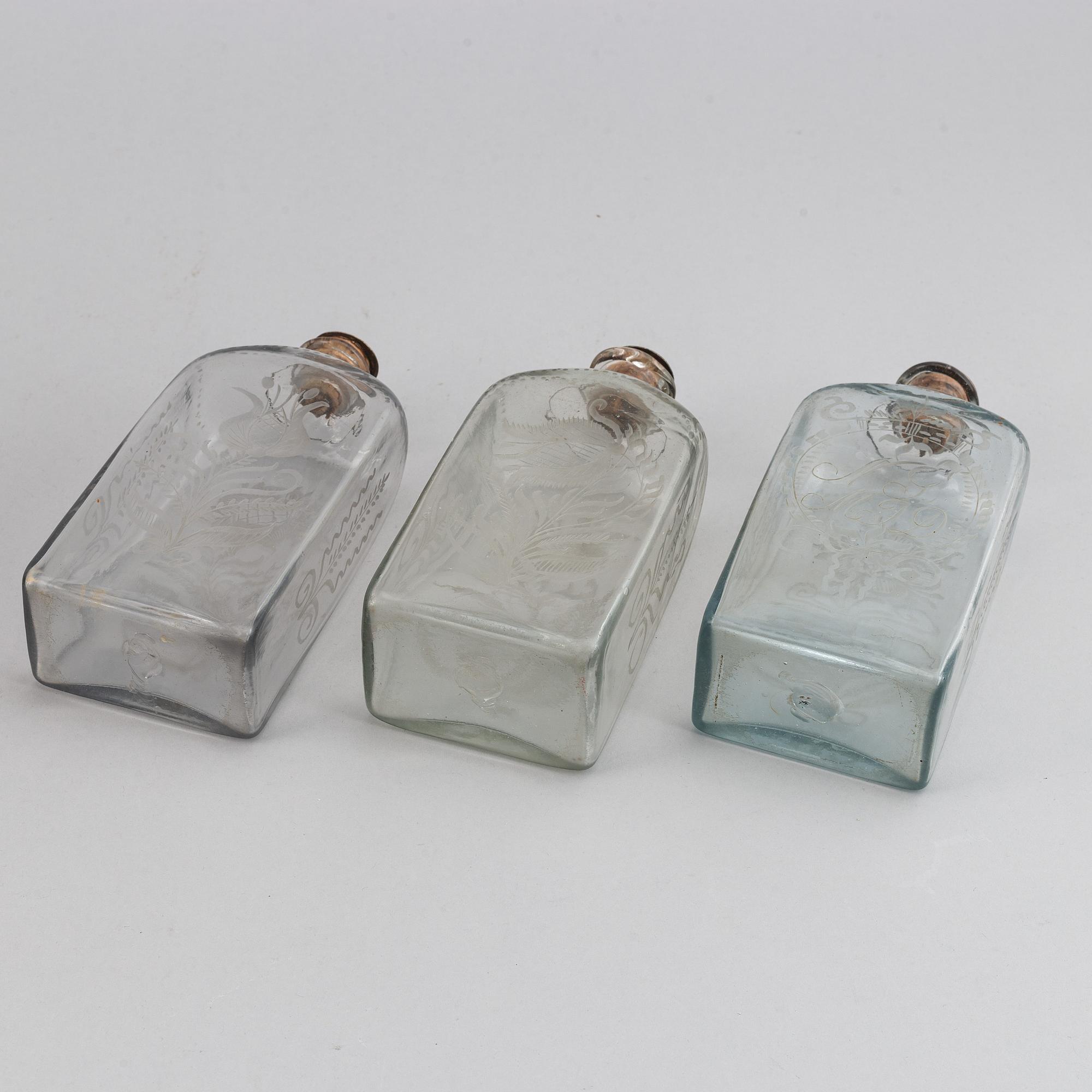 A late Empire mahogany box with three glass bottles, mid 19th Century.