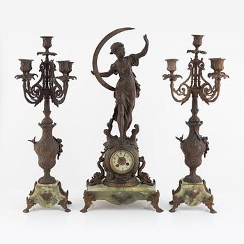 A mantel clock and pair of matching candelabra from the last quarter of the 19th century.