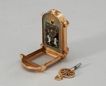 An early 20th century gold and enamel miniature clock.