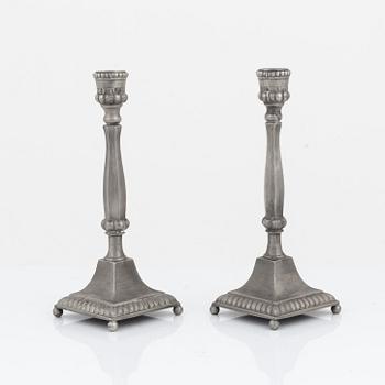 A pair of pewter candlesticks, dated 1835 & 1840.