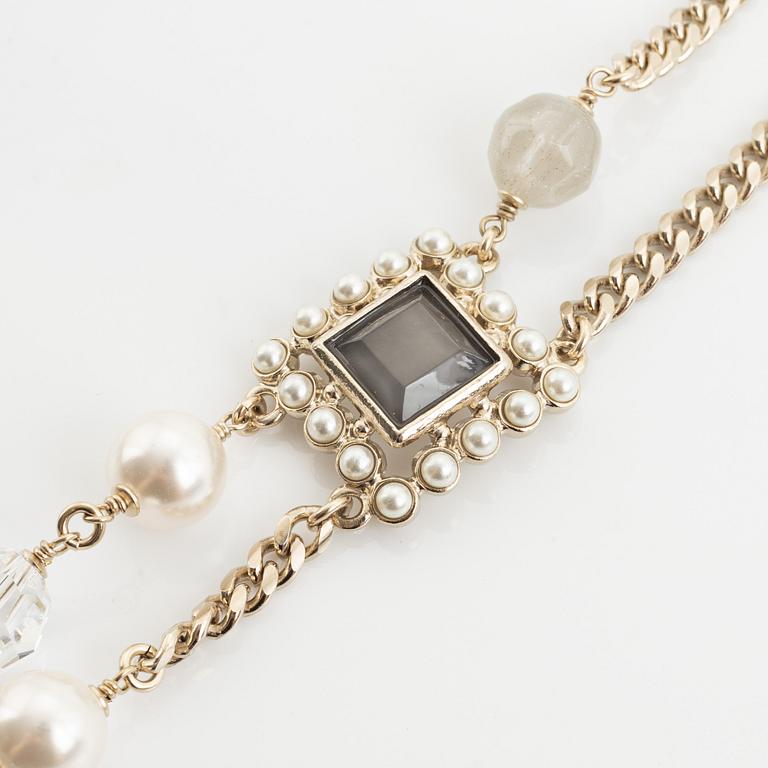 Chanel, a imitation pearl, and rhinestone necklace.