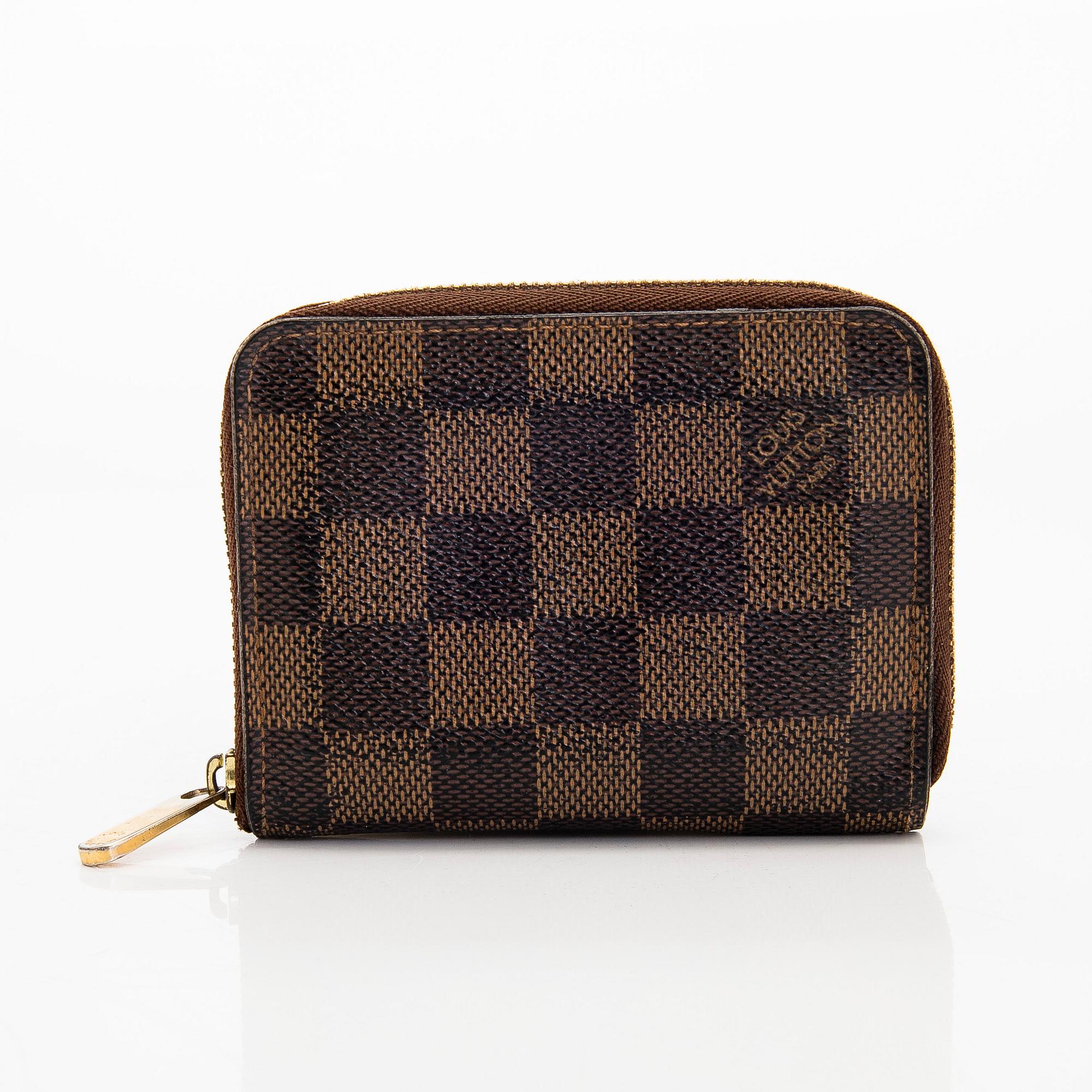Louis Vuitton, a 'Zippy Coin Purse' wallet and an 'Inventeur' belt.