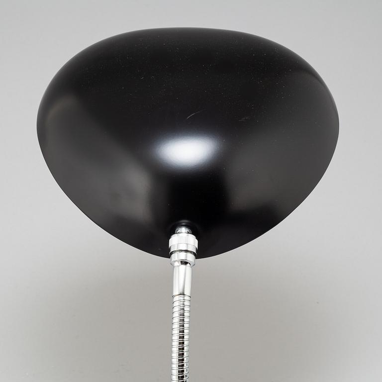 A 'Cobra' table lamp by Greta Magnusson Grossman, Gubi.