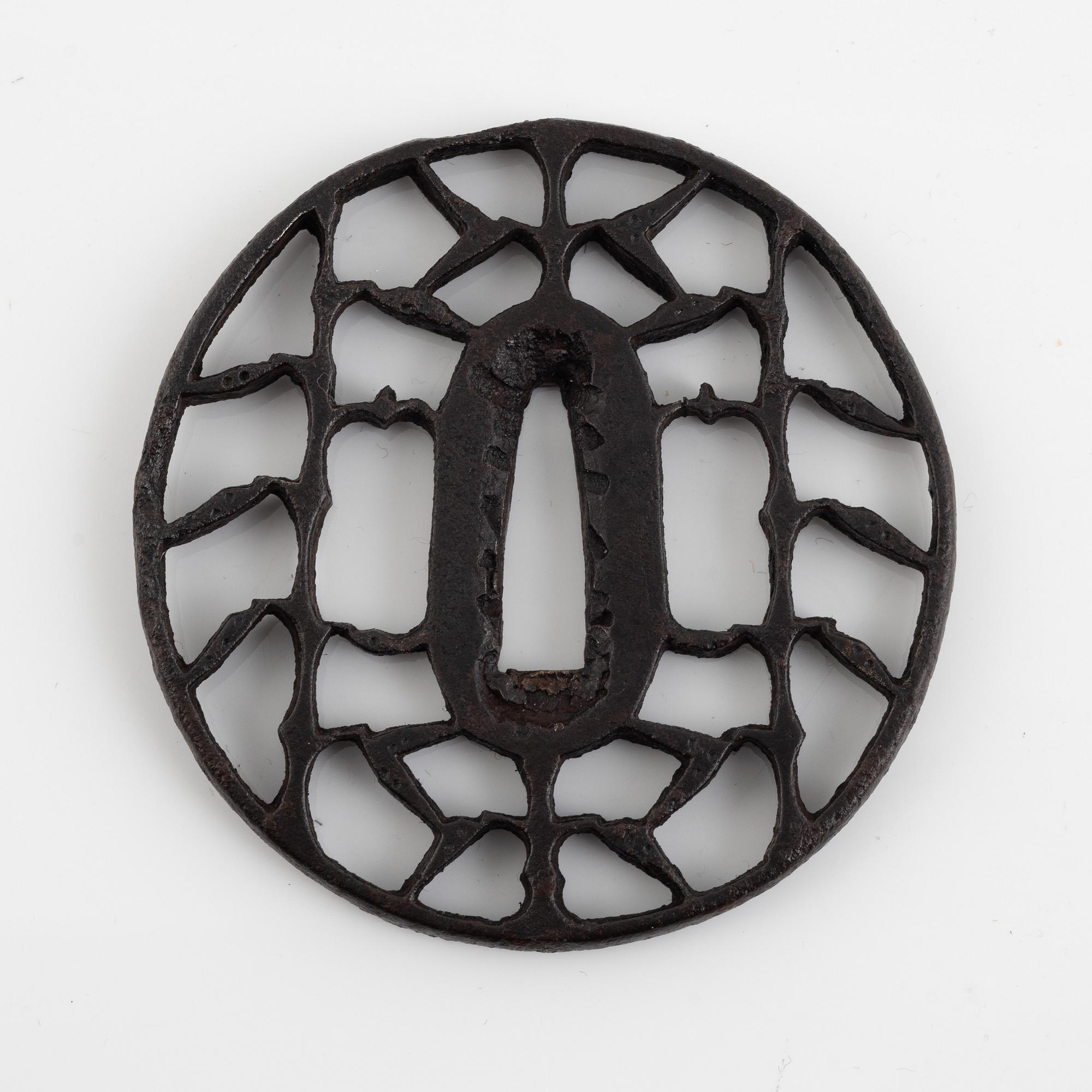 An iron open work, sukashi, Japanese tsuba, Edo (1603-1868). In a kiri box.