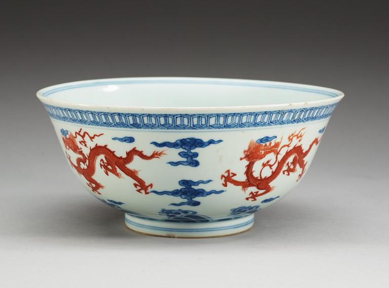 A blue and white bowl with a dragon in copper red, Qing dynasty with Xuande six character mark.