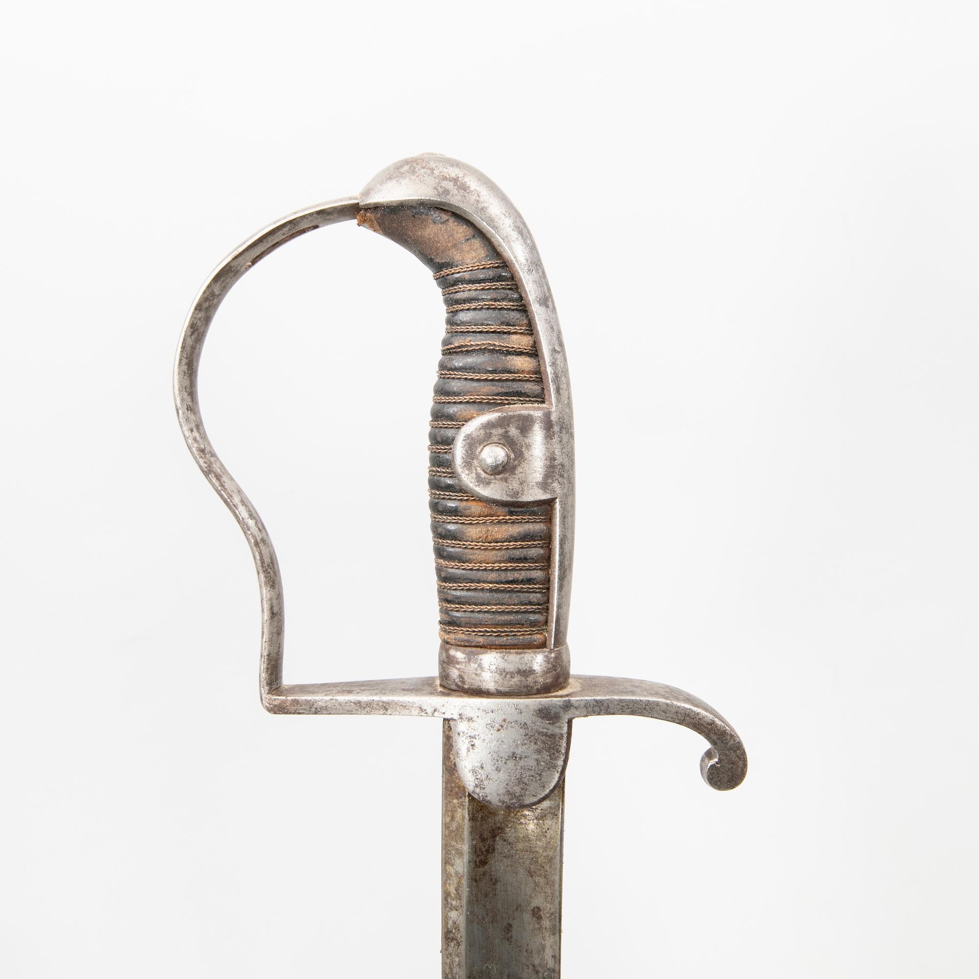 A German sabre with scabbard and a cutlass.