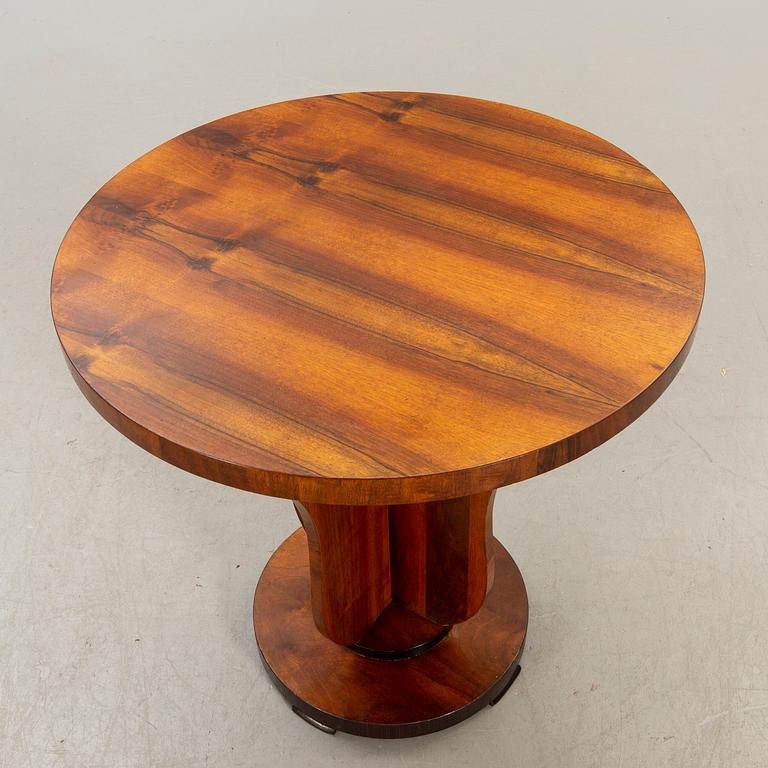An Art deco style walnut table later part of the 20th century.