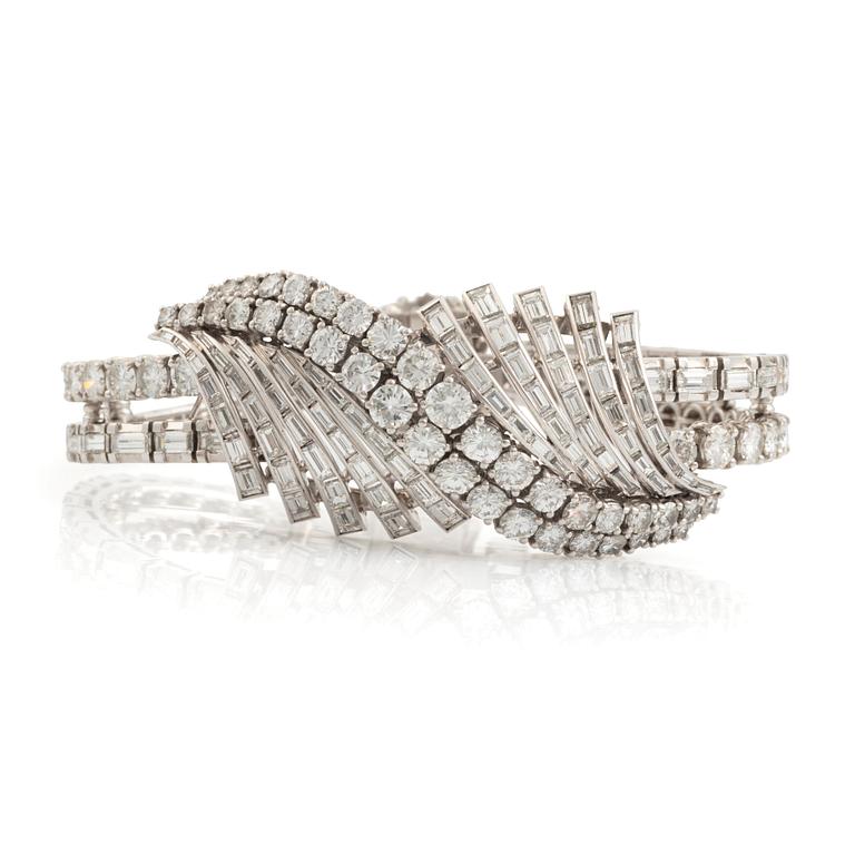 A platinum bracelet set with round brilliant- and baguette-cut diamonds.