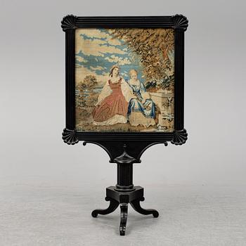 A mid 19th century fire screen.