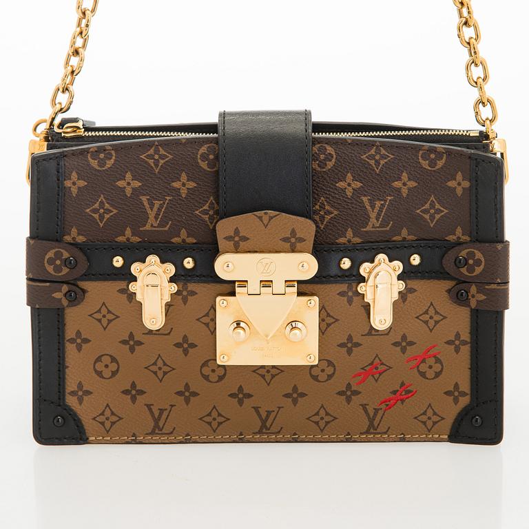 Louis Vuitton, a "Reverse Monogram Trunk Clutch" bag.