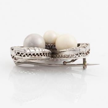 An antique shamrock pearl brooch.