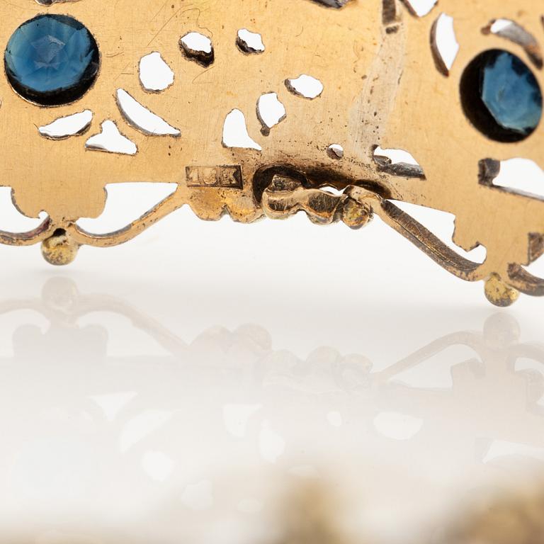 Bangle 18K gold and silver with rose-cut diamonds and blue stones, possibly sapphires.