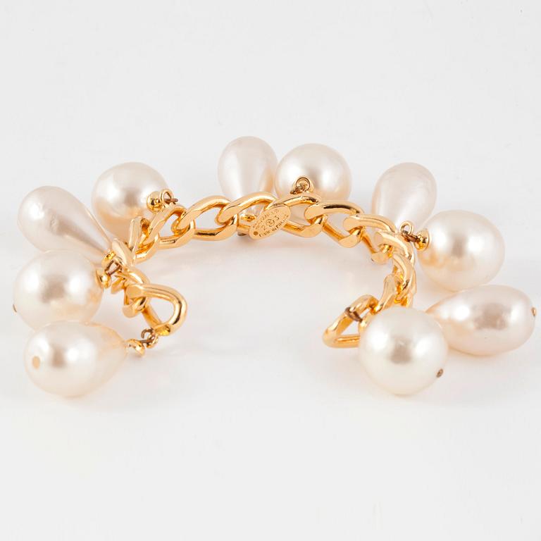 CHANEL, a goldcolored bracelet with decorative pearls.