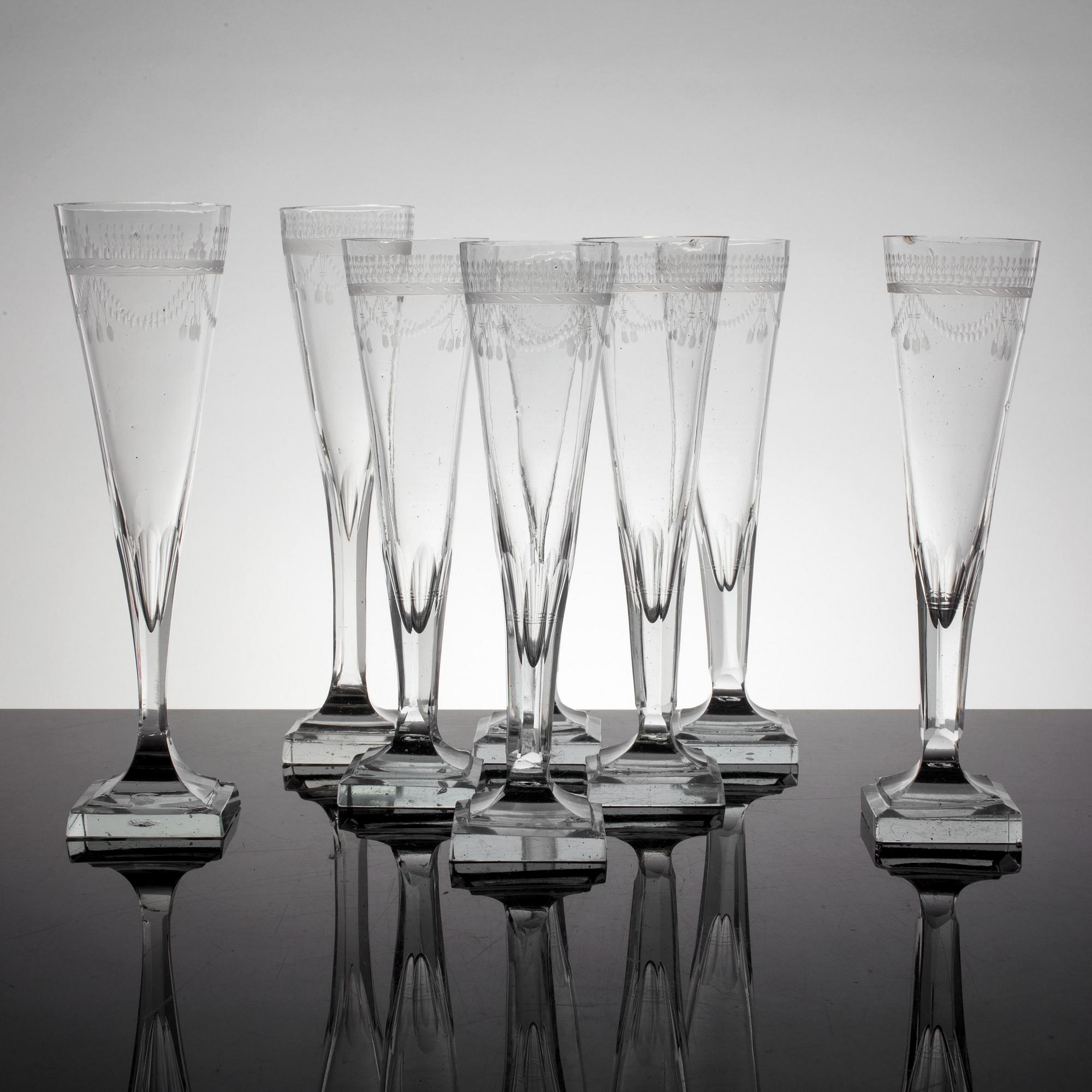 A set of 8 early 19th century champagne glasses.