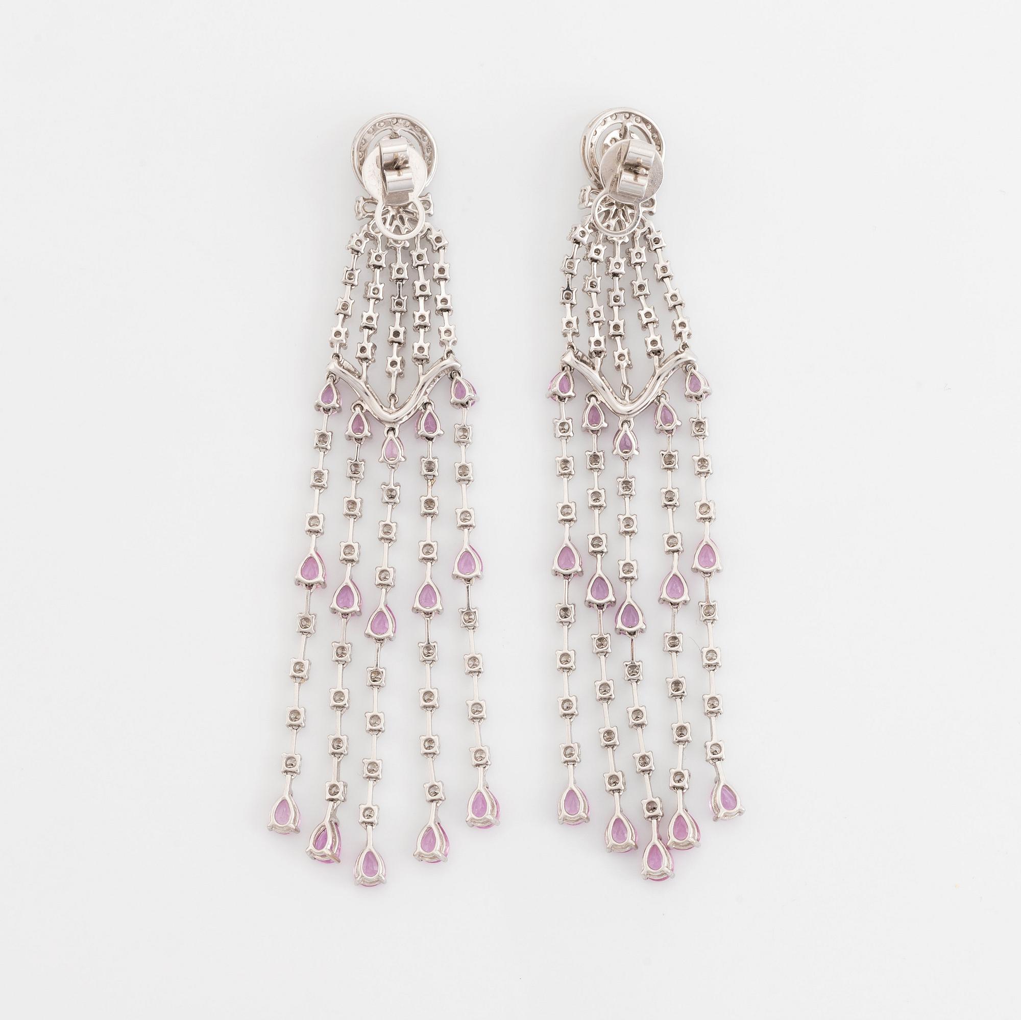 A pair of 18K white gold earrings set with faceted pink sapphires and round brilliant-cut diamonds.