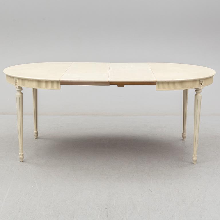 A set of eight chairs and a dining table. Gustavian style, second half of the 20th century. 2 leaves included.